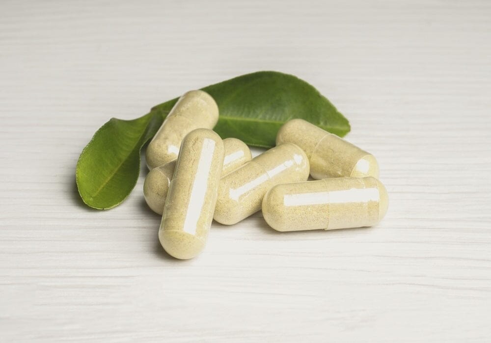 Supplements capsules with some herbal leaves