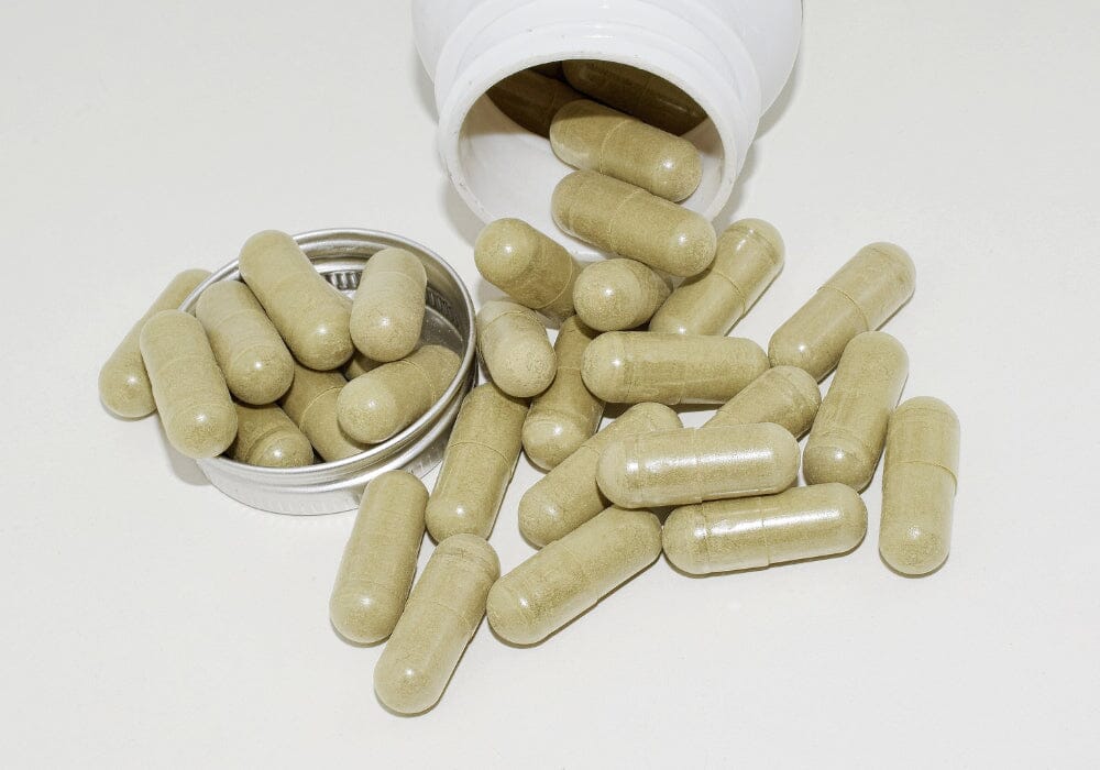 Supplement capsules emptied out of a plastic bottle.