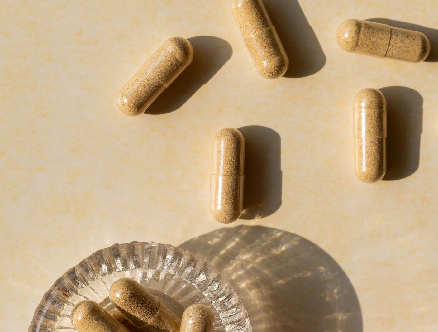 Supplement capsules emptied out of a plastic bottle.