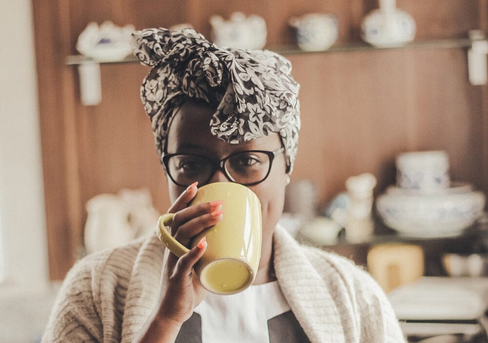 Woman wearing a headscarf drinking from a mug